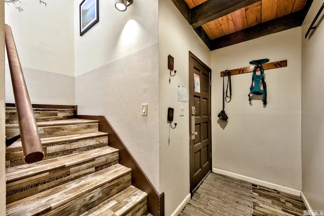 entrance foyer with beamed ceiling, wood ceiling, and dark wood-type flooring