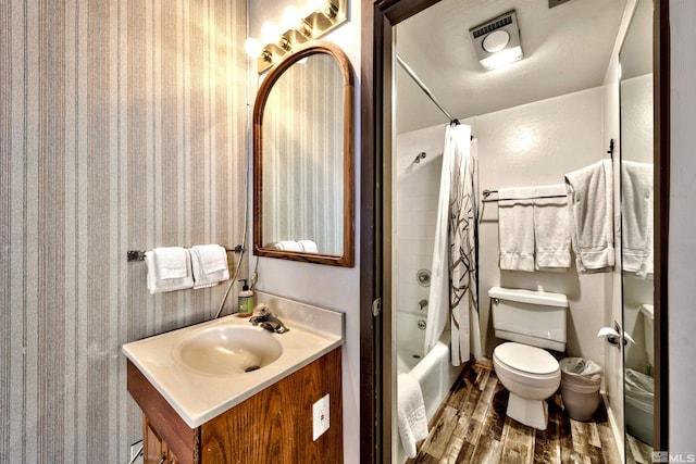 full bathroom featuring vanity, toilet, wood-type flooring, and shower / tub combo with curtain