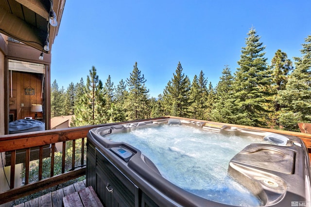 wooden deck with a hot tub