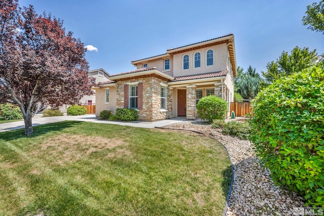 mediterranean / spanish-style house with a front yard