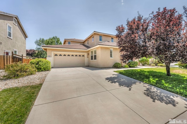 mediterranean / spanish-style home featuring a front lawn and a garage