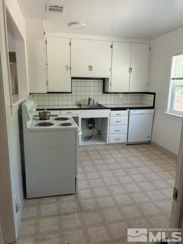 kitchen with white cabinets, white appliances, and backsplash