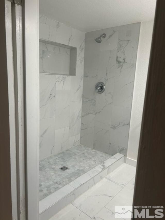 bathroom with tiled shower