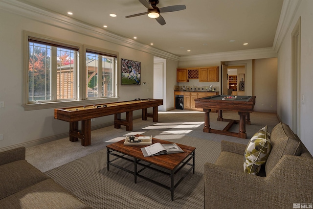 playroom with light carpet, bar area, ceiling fan, and ornamental molding