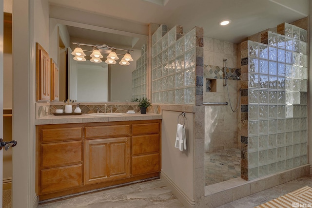 bathroom featuring a tile shower and vanity