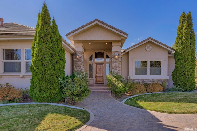 property entrance featuring a lawn