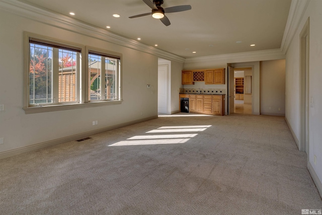 unfurnished living room featuring ceiling fan, ornamental molding, and light carpet