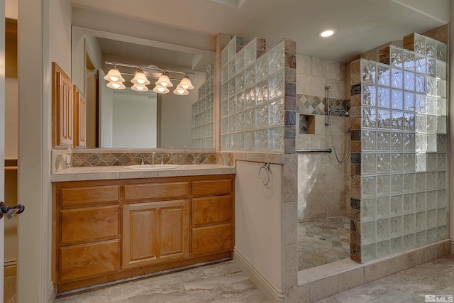 bathroom with decorative backsplash, vanity, and tiled shower