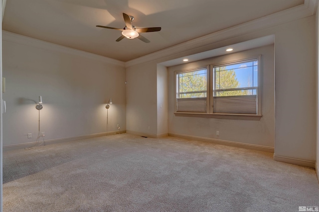 carpeted empty room with ceiling fan and ornamental molding