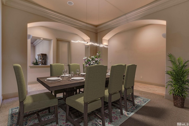 carpeted dining room featuring ornamental molding