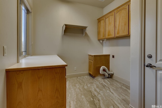 clothes washing area with cabinets, light wood-type flooring, and hookup for an electric dryer