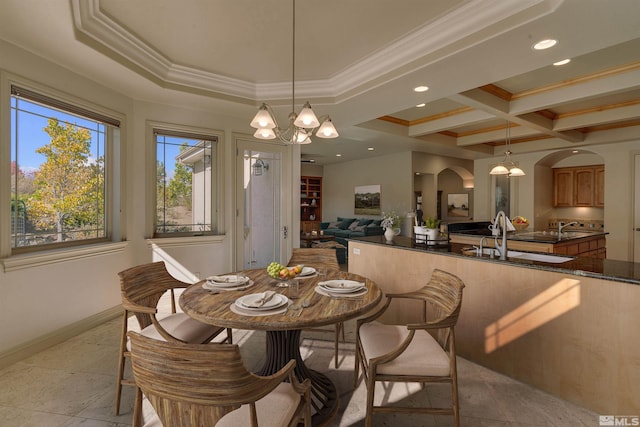 dining room featuring coffered ceiling, ornamental molding, sink, a notable chandelier, and beamed ceiling