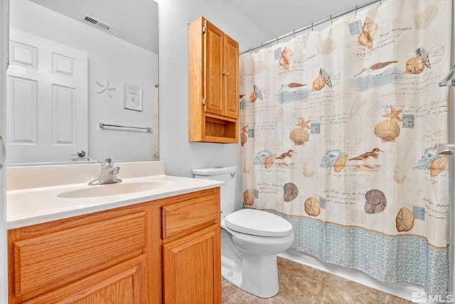 bathroom with toilet, a shower with curtain, vanity, and tile patterned floors