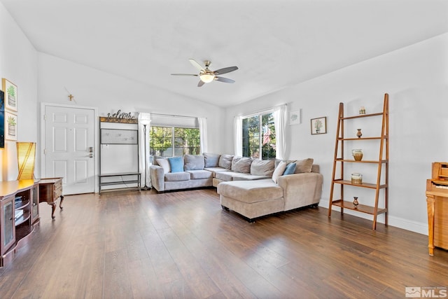 living room with dark hardwood / wood-style floors, ceiling fan, and vaulted ceiling