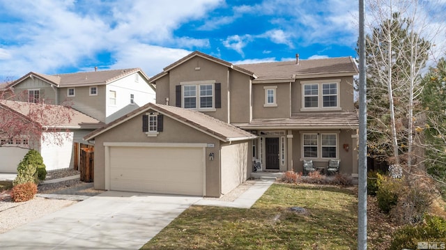 view of front of home featuring a garage and a front lawn