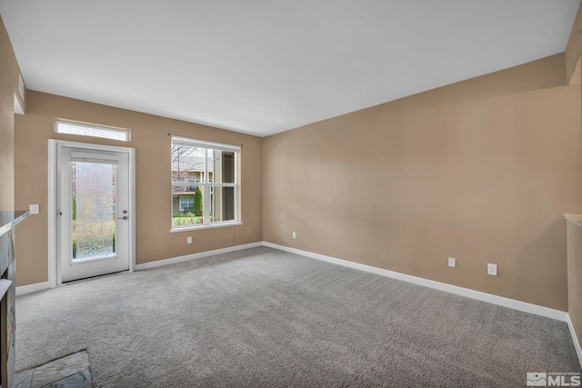 empty room with carpet and baseboards