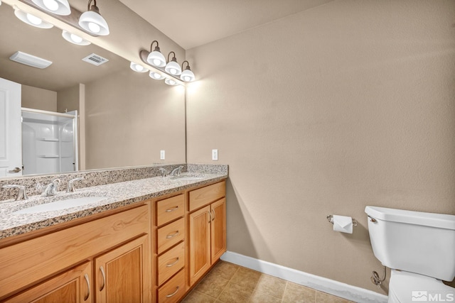 bathroom featuring a shower with shower door, visible vents, a sink, and double vanity