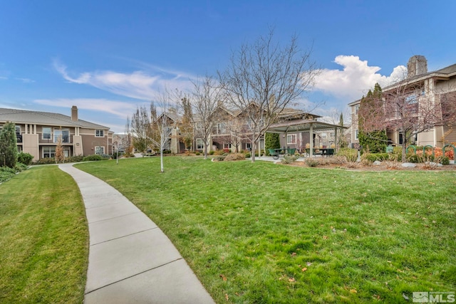 view of community with a lawn and a residential view