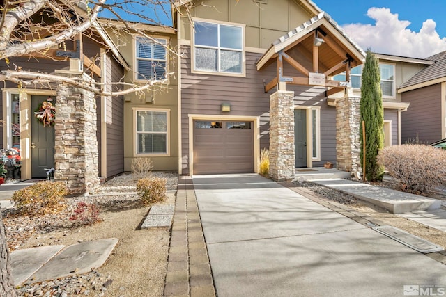 view of front of house featuring concrete driveway and an attached garage