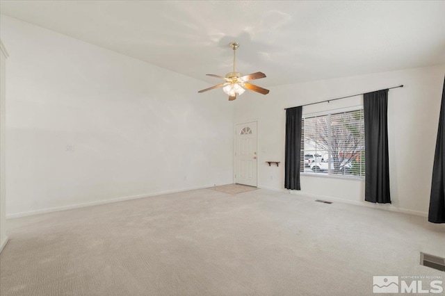 carpeted empty room featuring ceiling fan