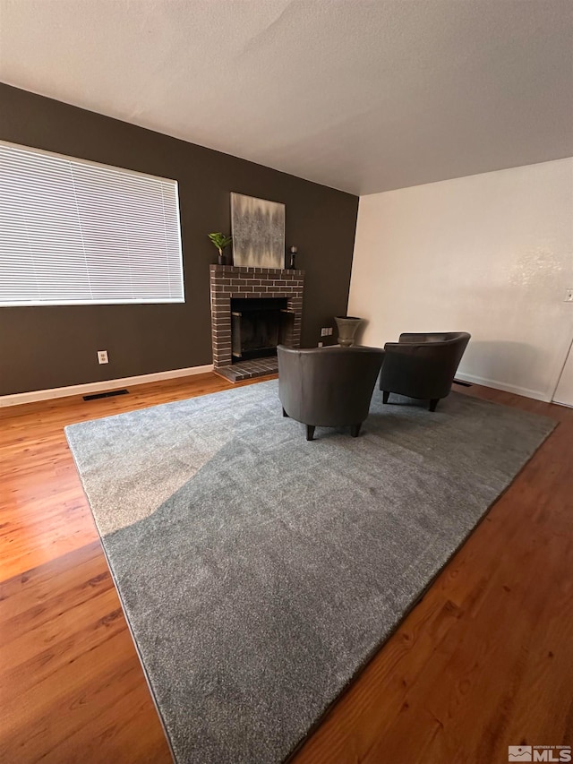 living room with hardwood / wood-style flooring and a fireplace