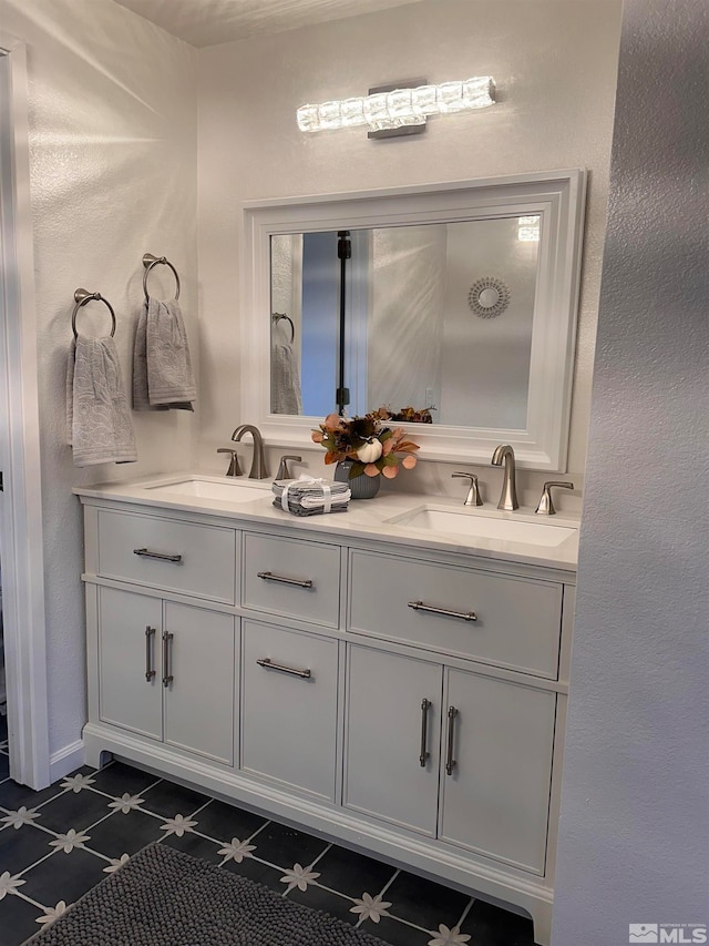 bathroom featuring tile patterned flooring and vanity