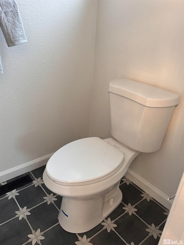 bathroom with tile patterned flooring and toilet