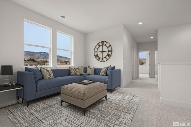 living room featuring a mountain view and light colored carpet