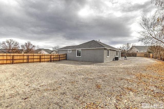 rear view of property with central AC unit