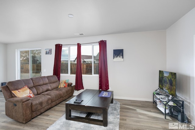 living room with light hardwood / wood-style flooring