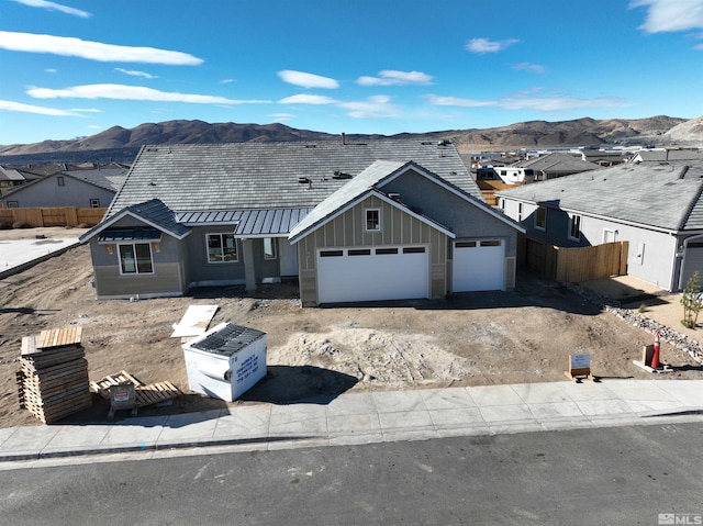 view of front of home with a mountain view and a garage