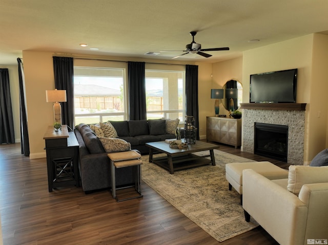 living room featuring a fireplace, dark hardwood / wood-style floors, and ceiling fan