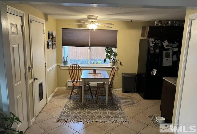 dining area with ceiling fan and light tile patterned flooring