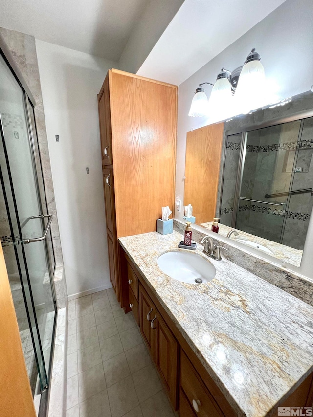 bathroom with tile patterned floors, vanity, and a shower with shower door