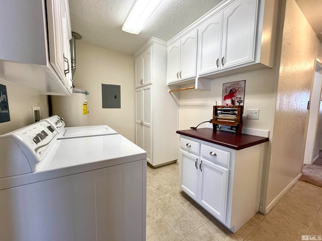 laundry room with cabinets, a textured ceiling, water heater, washing machine and dryer, and electric panel