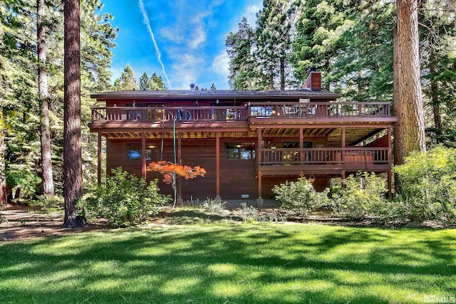 back of house with a lawn and a wooden deck