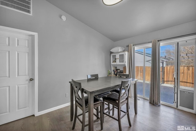 dining area featuring dark hardwood / wood-style flooring and lofted ceiling