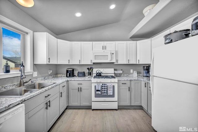 kitchen with sink, light hardwood / wood-style flooring, lofted ceiling, white appliances, and white cabinets