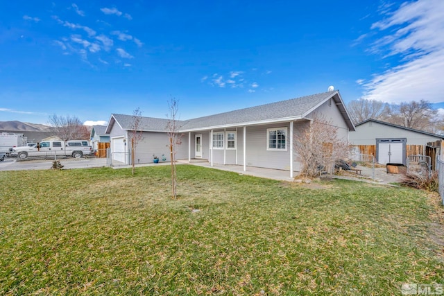 back of property with a lawn and a garage