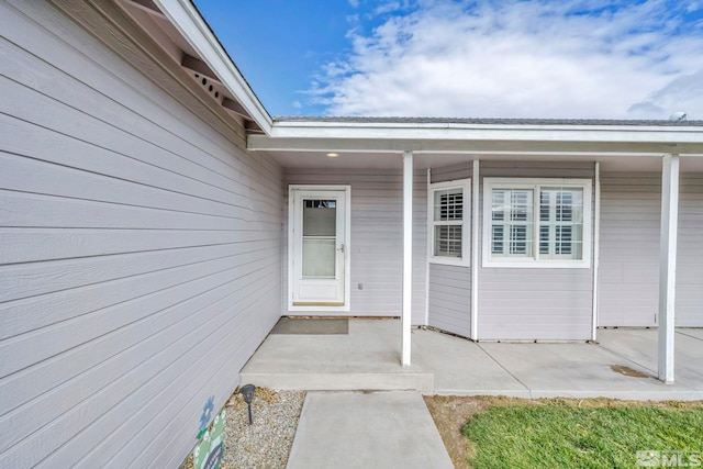 property entrance featuring a patio area