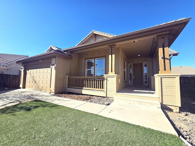 single story home featuring covered porch and a garage