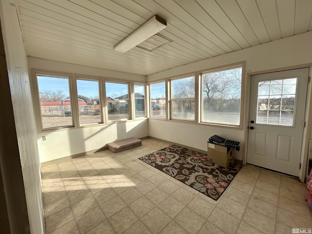 unfurnished sunroom featuring a healthy amount of sunlight