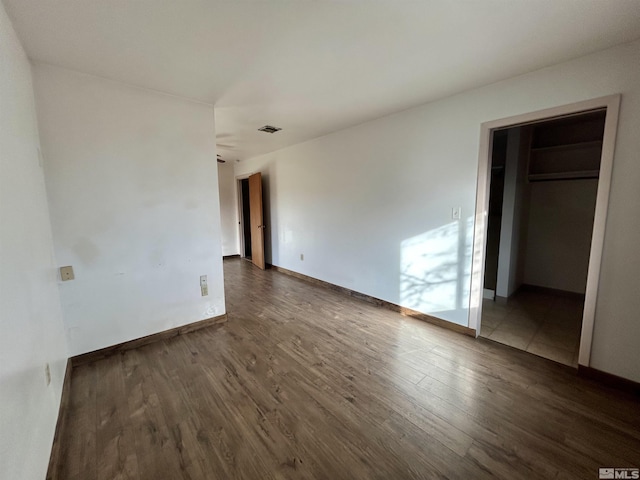 unfurnished bedroom with dark wood-type flooring