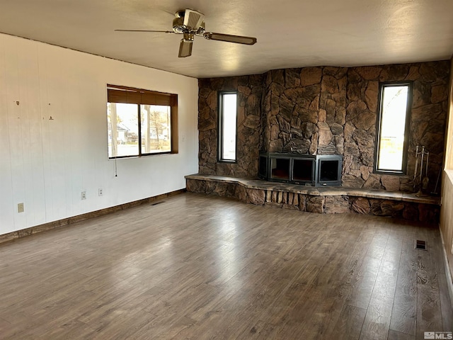 unfurnished living room featuring ceiling fan, a fireplace, and hardwood / wood-style floors