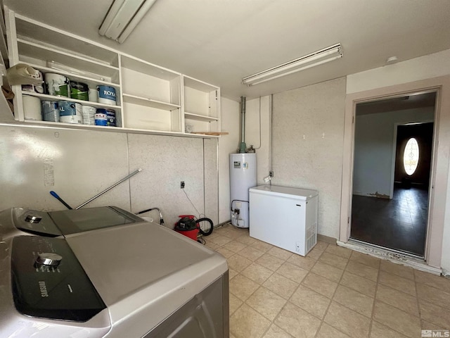 clothes washing area with water heater and washing machine and clothes dryer