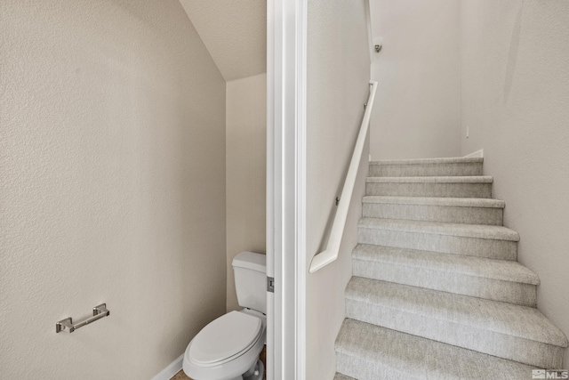 stairs with a textured ceiling