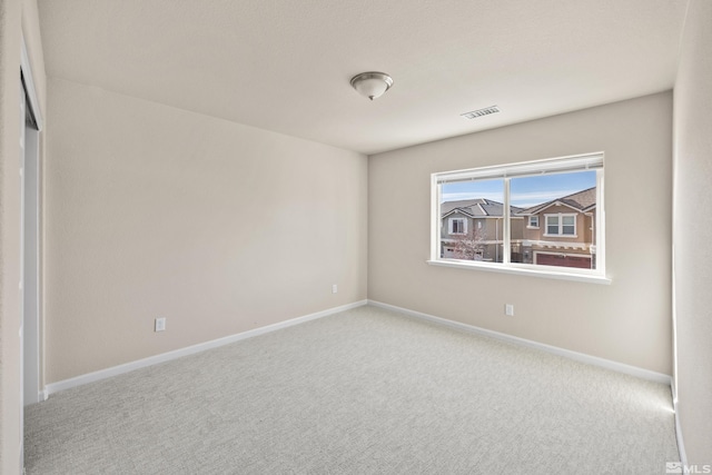 unfurnished room featuring light colored carpet