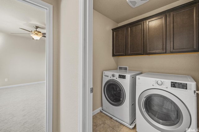 laundry area featuring cabinets, light carpet, ceiling fan, independent washer and dryer, and a textured ceiling