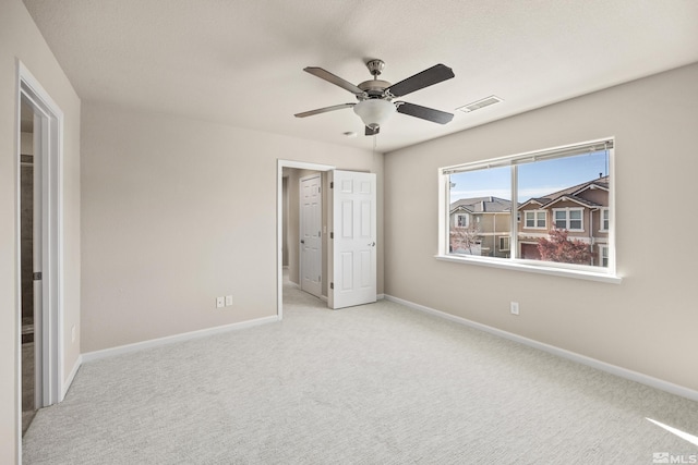 unfurnished bedroom featuring ceiling fan and light carpet