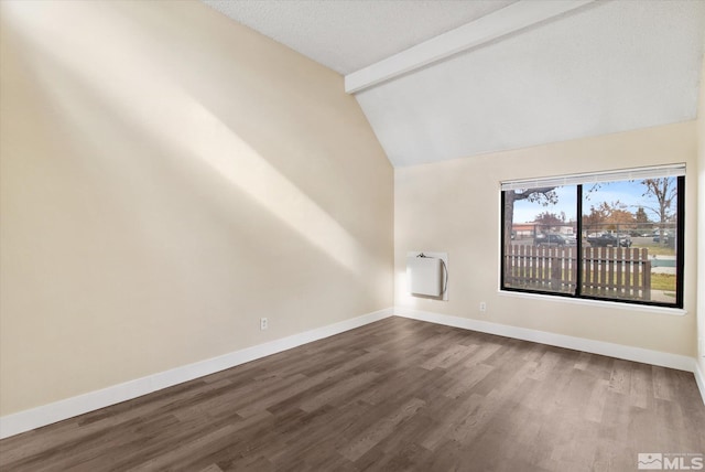 spare room featuring heating unit, hardwood / wood-style floors, lofted ceiling with beams, and a textured ceiling